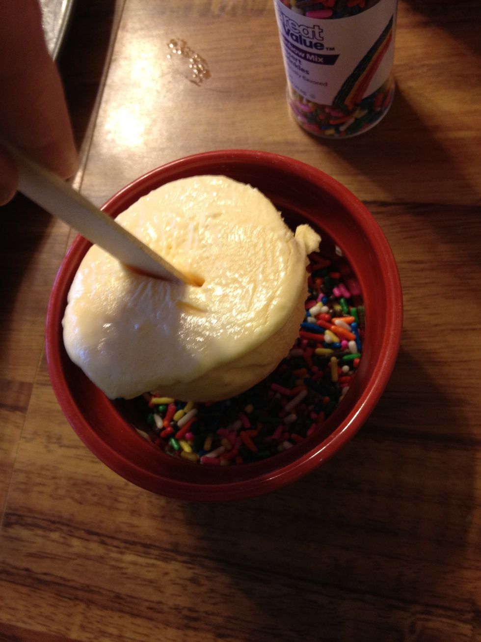 Insert ice cream into sprinkles.