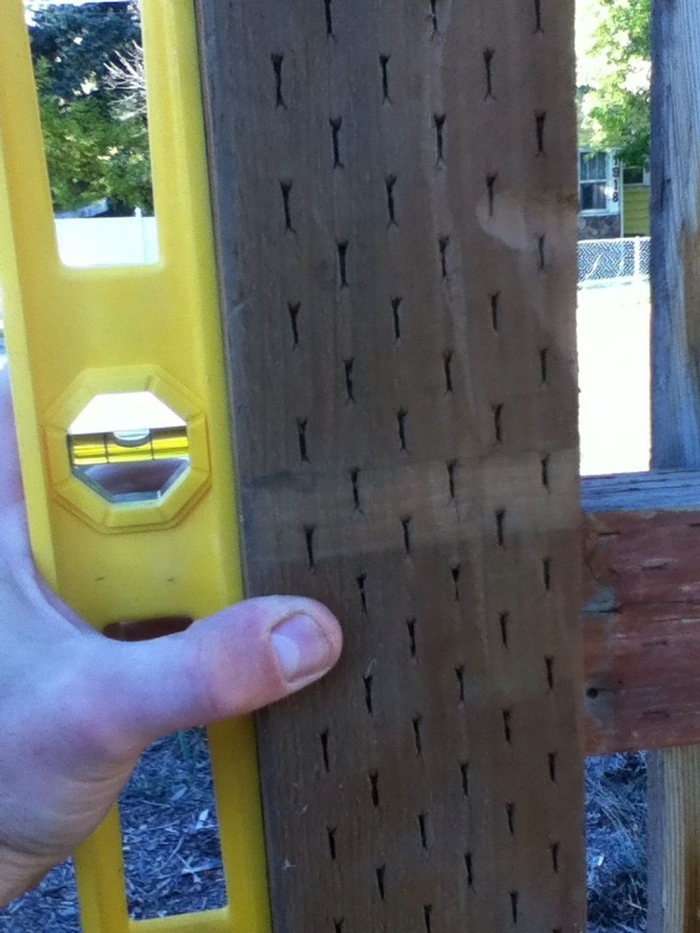 Insert new post and ensure it is straight. Use the level.