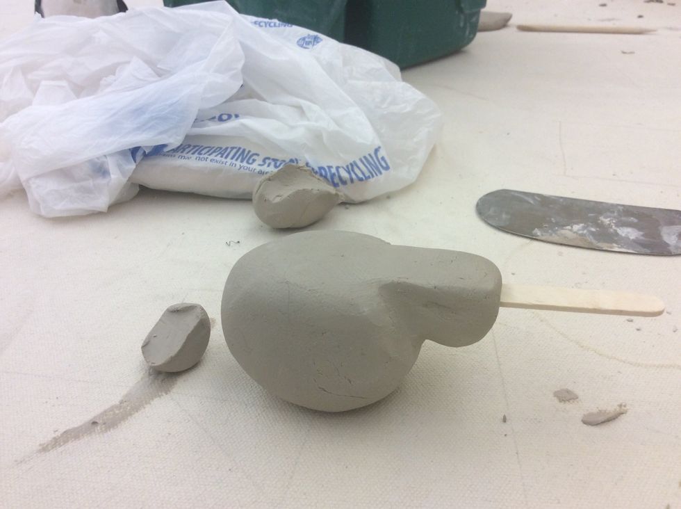 Insert Popsicle stick into mouthpiece so that the Popsicle stick touches the top of the inside of the ball.