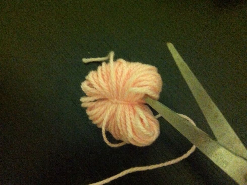 Insert scissor into the loops and start cutting