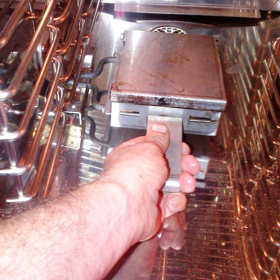Insert smoker box with soaked wood chips inside.
