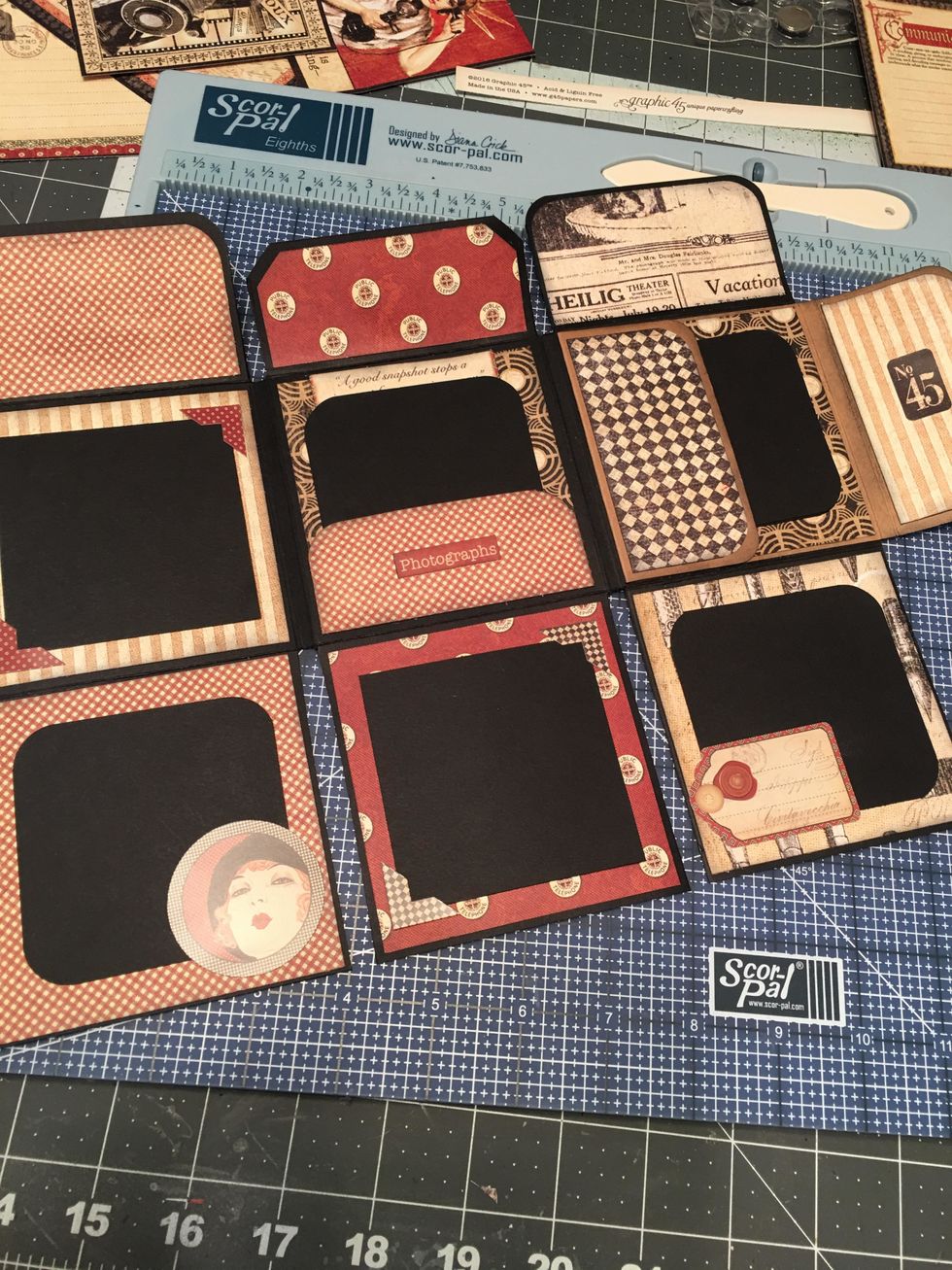 Insert some of the photo mats into the pockets and attach others to the sections. Add corners and decorative stickers as desired from the collection sticker sheet.