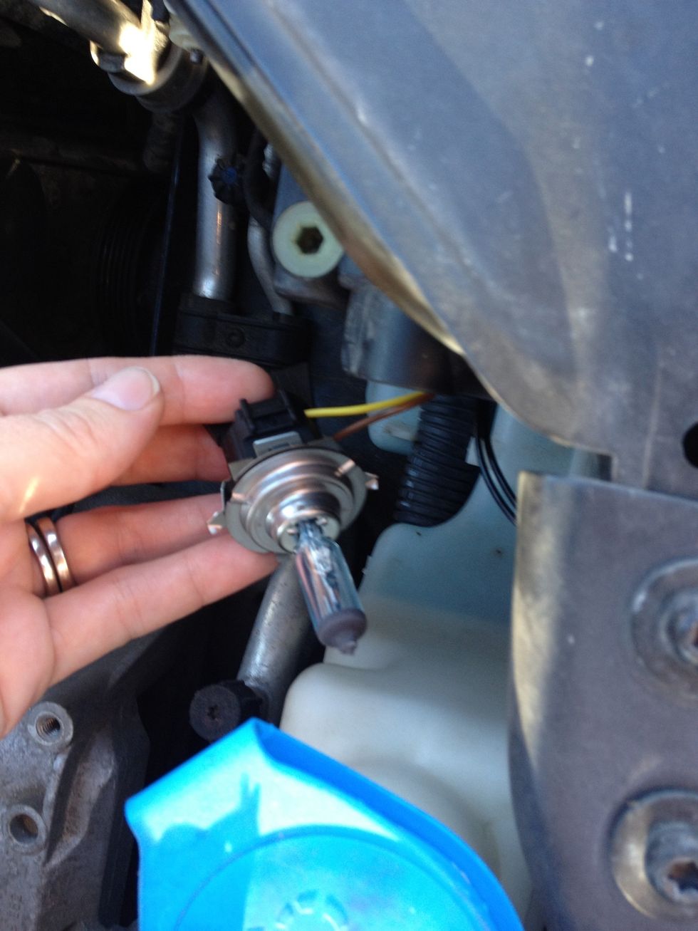 Insert the bulb into the socket ensuring the tabs are lined up. Note the winged tab that I'm holding onto. This is what you twist slightly when reinstalling or removing the socket from the housing.