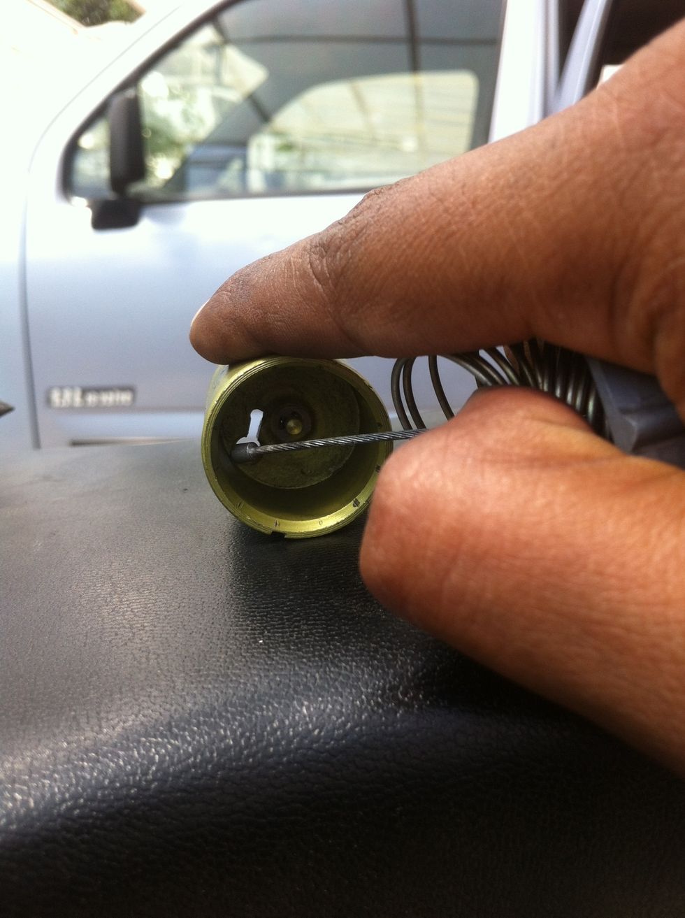 Insert the cable free end through the big hole in the carburetor piston.