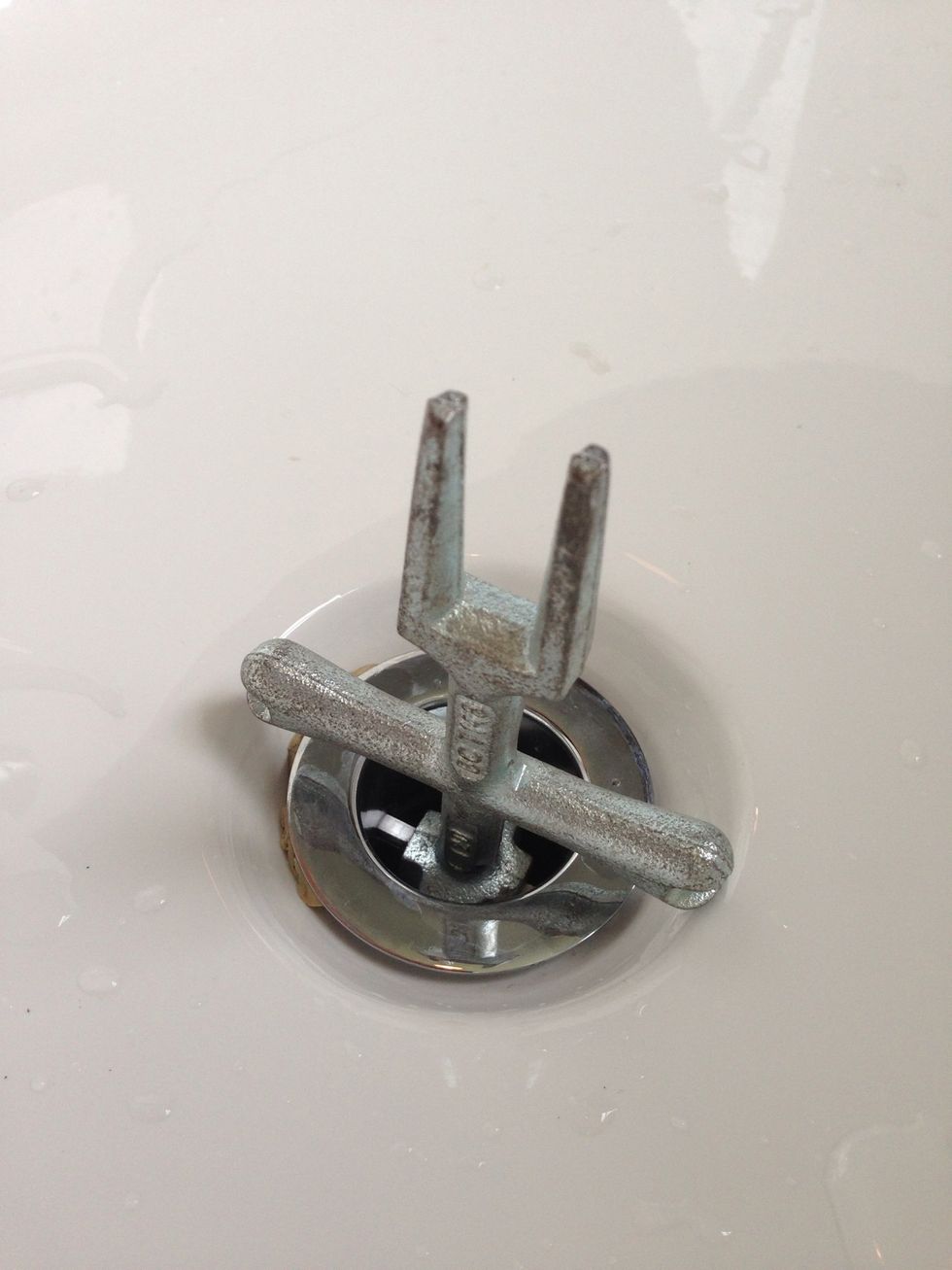 Insert the drain wrench into the drain and rotate counter clockwise to loosen the drain. It will probably be pretty hard to turn and feel stuck, but keep trying it will loosen up.