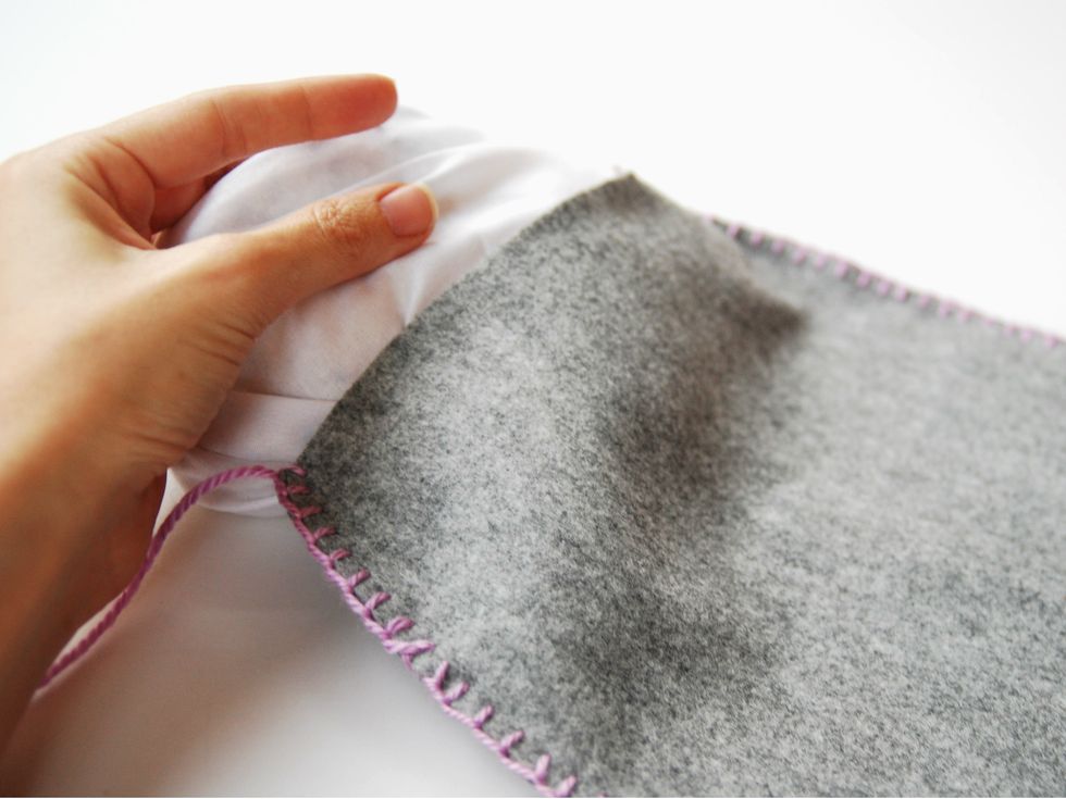 Insert the inside stuffed pillow into the felt cushion and complete the hand stitching to close.