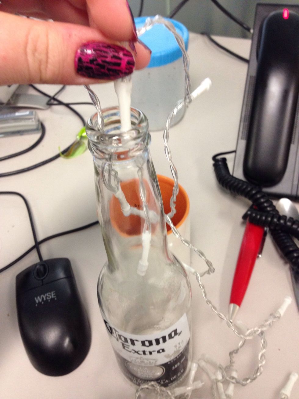 Insert the lights into the clean dry corona bottle, with the led facing downwards. This prevents extra pressure on the wiring.
