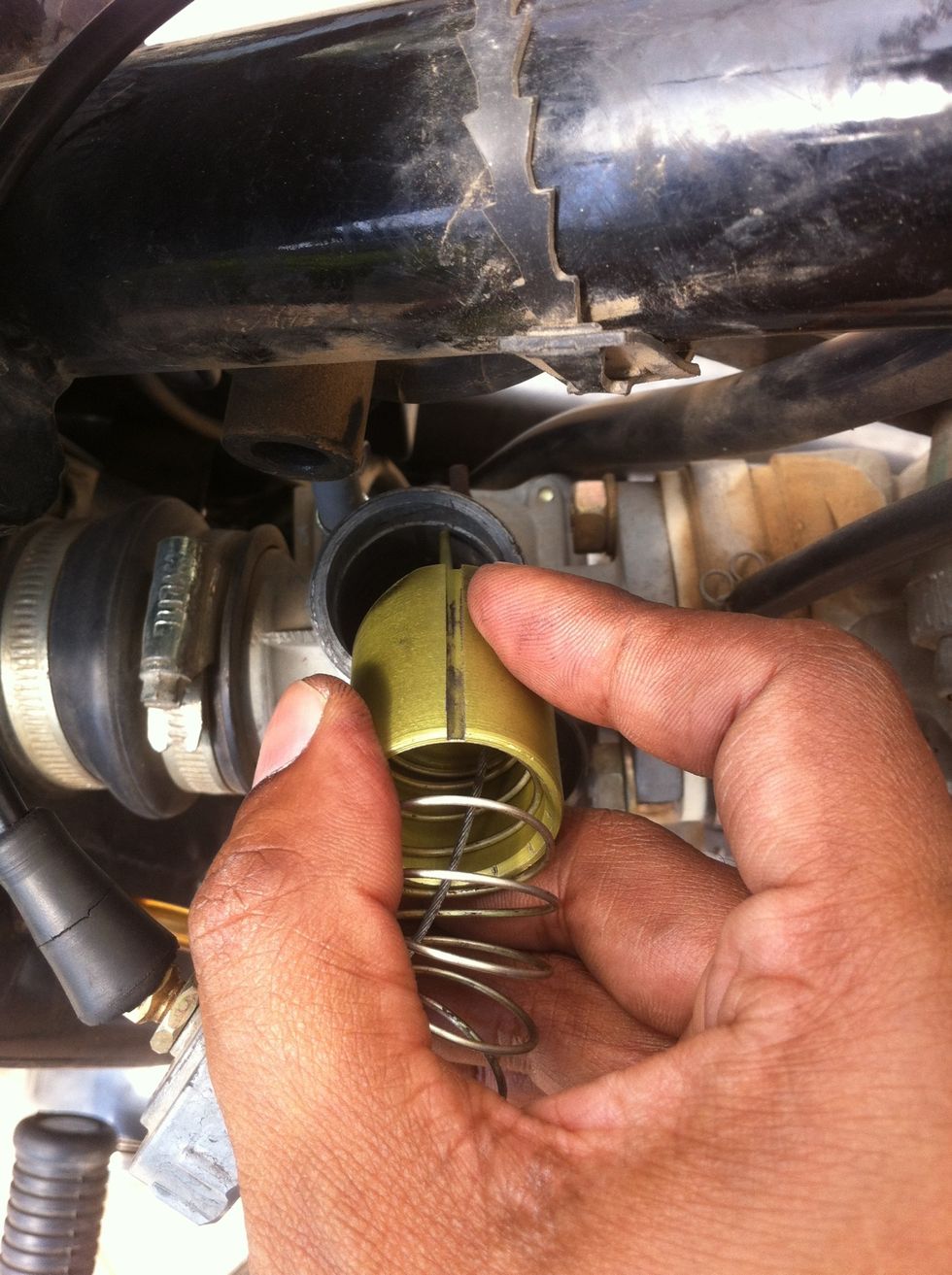 Insert the piston by aligning the slot on the side of the piston with the locking pin inside the carburetor bore. ( Not the guide pin as shown before ).