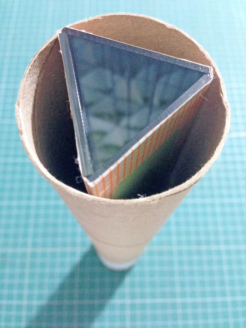 Insert the prism from the other end of the kitchen roll as shown... At this point, you would be able to see the patterns created within the kaleidoscope...