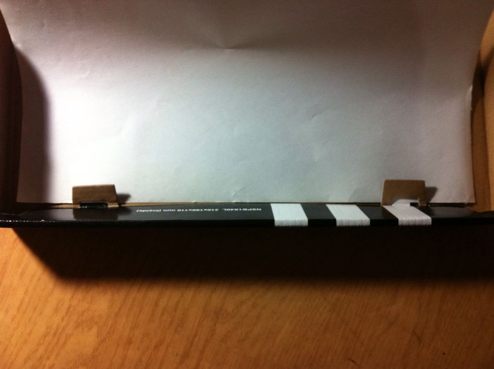 Insert the sheet of paper and press firmly on the bluetack.