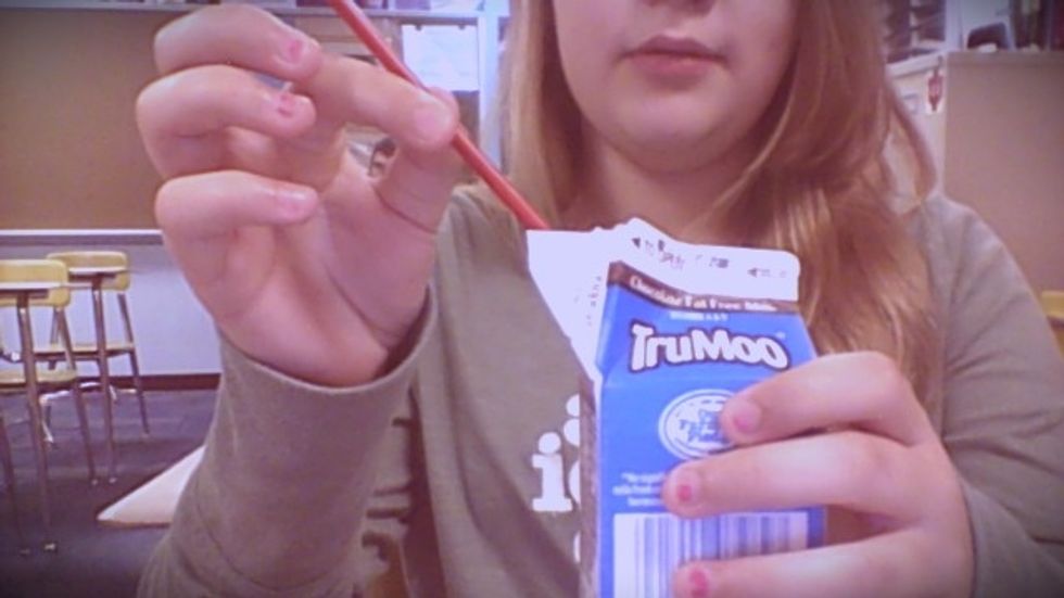 insert the straw into the milk spout