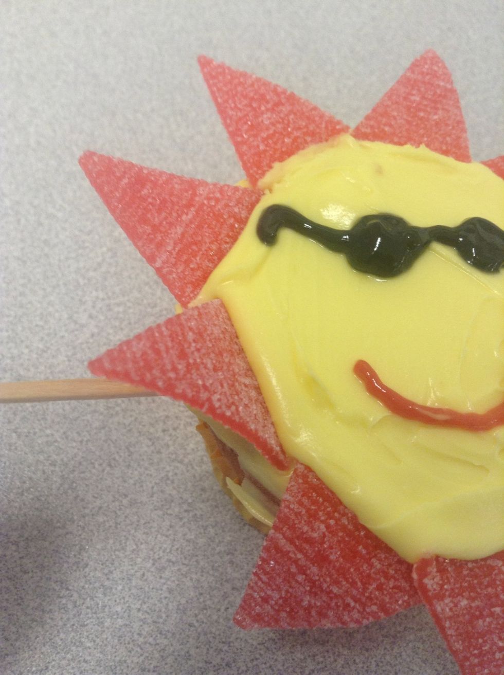 Insert the toothpicks under the triangular sour straps to keep them raised.