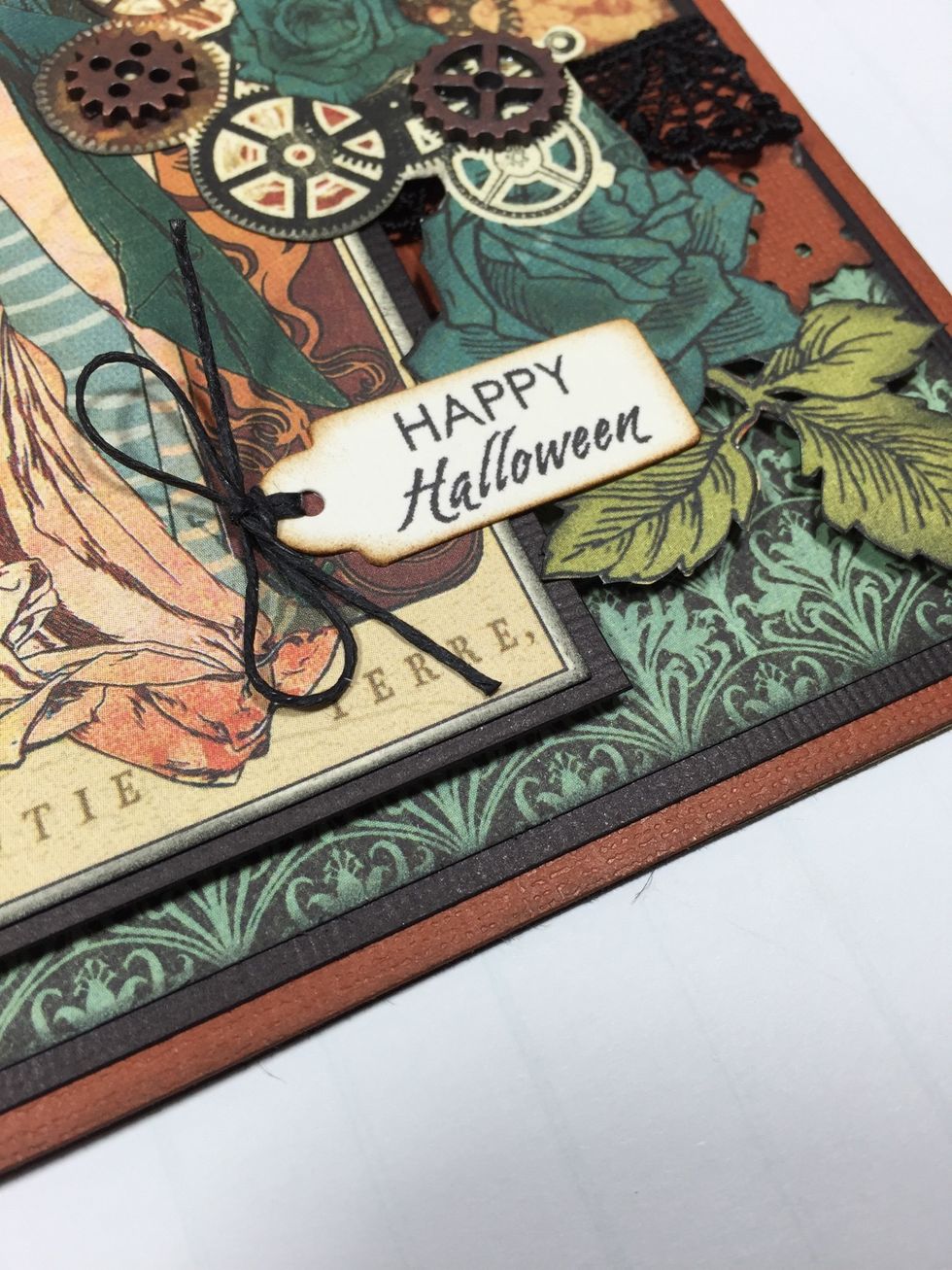 Insert waxed twine through the stamped sentiment tag and tie into a bow, then adhere to card.