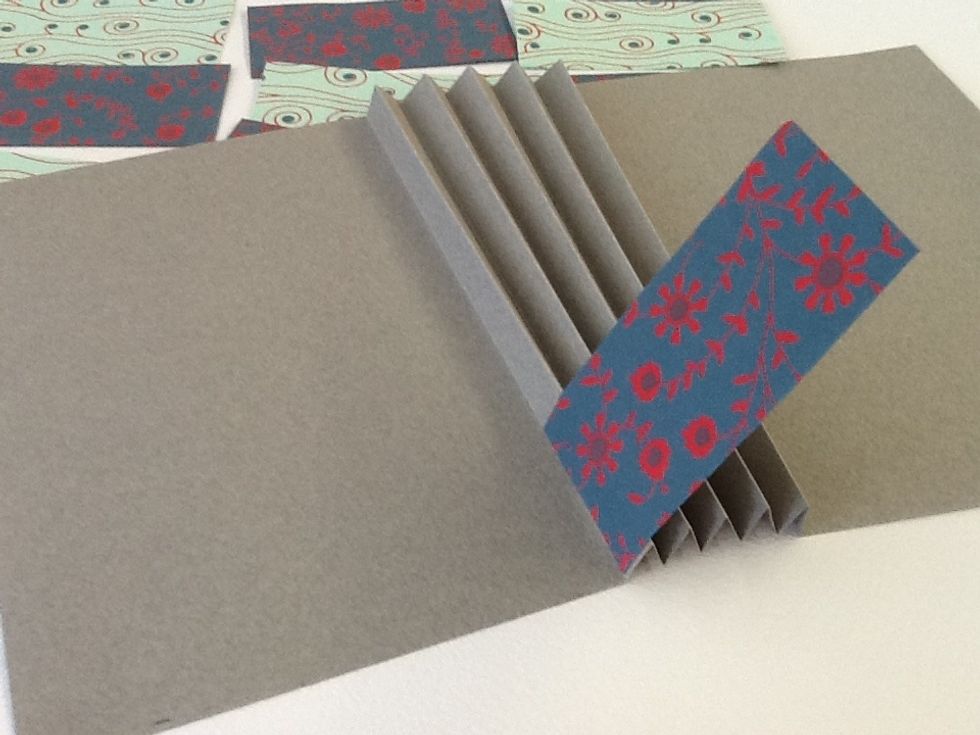 Insert your first flag along the outer edge of the first accordion fold.