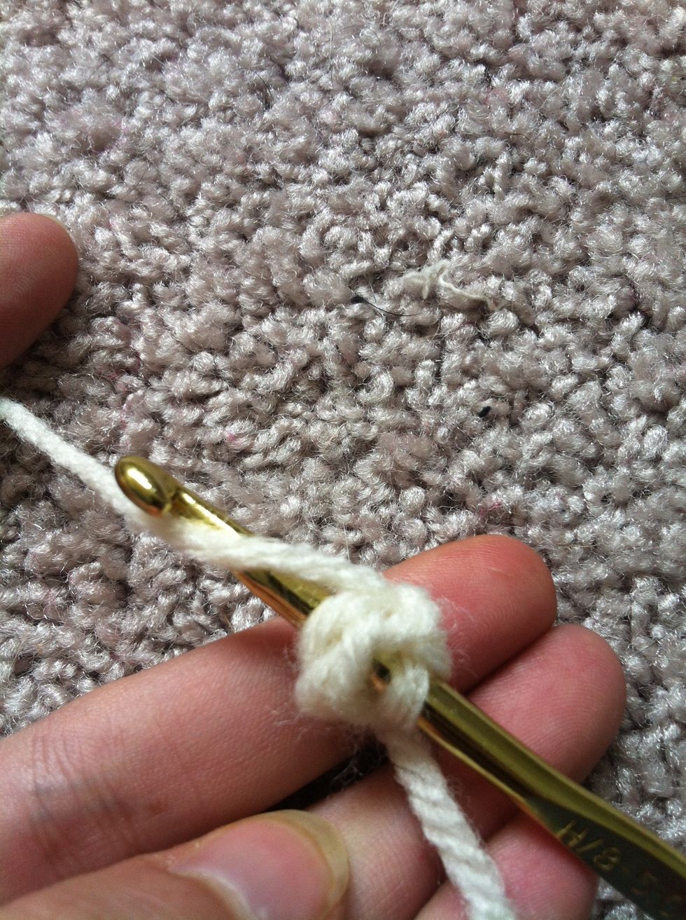 insert your hook through the middle of your circle (not the chains) and pull your yarn through.