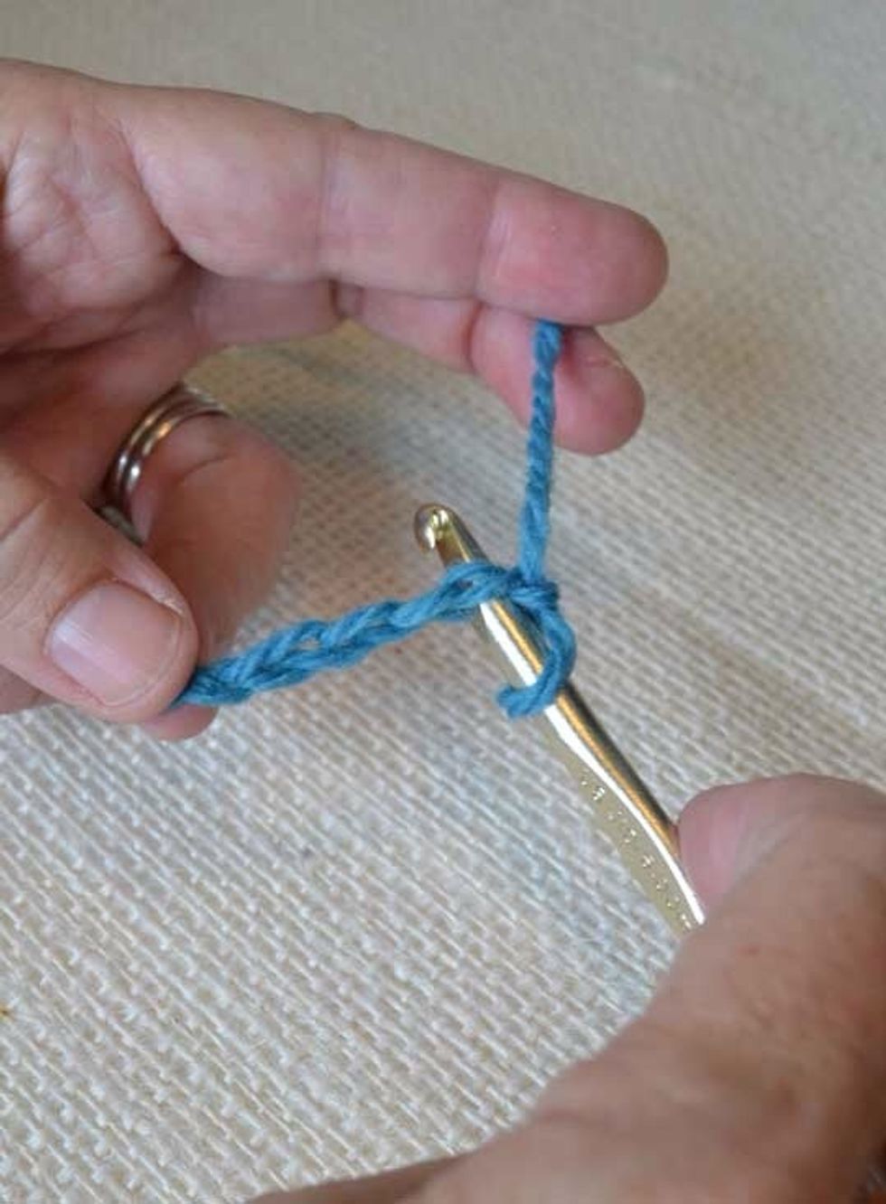 Insert your hook under the second complete V, excluding the one on the hook.