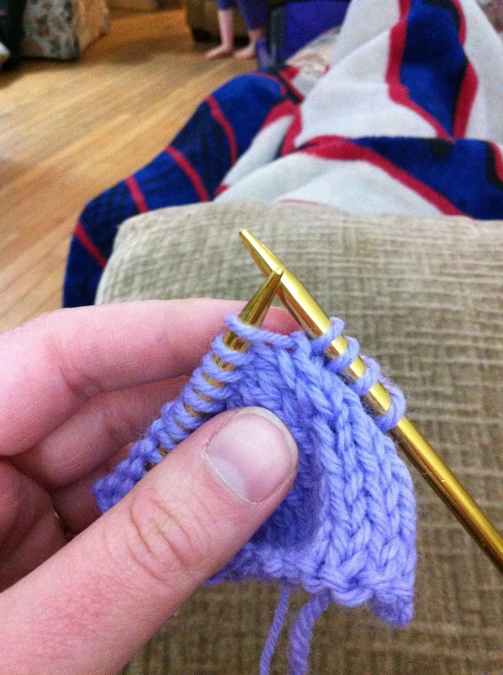 Insert your left needle into the loop between the stitch on the right and left needles.