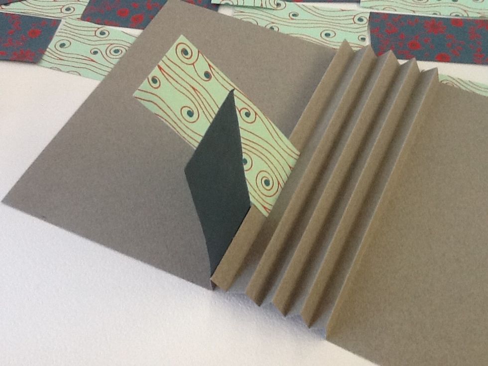 Insert your second flag just above the first, but on the inside of the accordion fold.