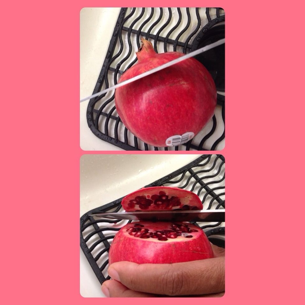 Inside a clean sink, cut about a half inch off the top of your pomegranate