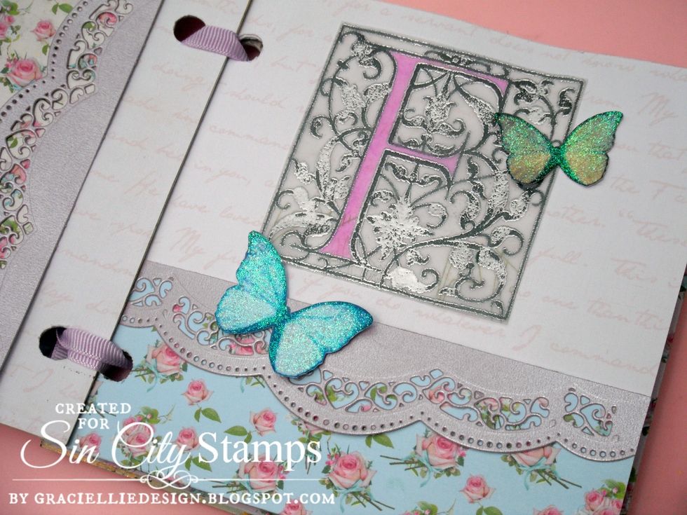 Inside I decorated the pages with more butterflies, die cut borders & printed elements such as this vellum letter. I added color to the letter with an alcohol marker. This page also has a nice pocket.