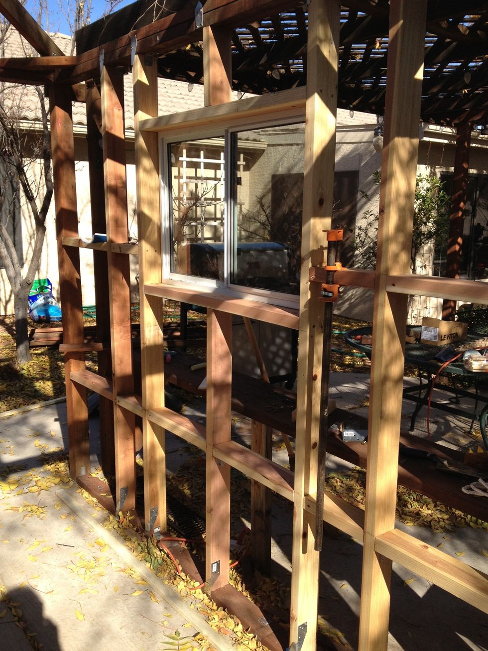 Inside looking out. The cement floor was poured for the hot tub. The gazebo had 4x4 corner posts. Anchoring the 2x4's to the cement between the 4x4 posts was the most difficult.