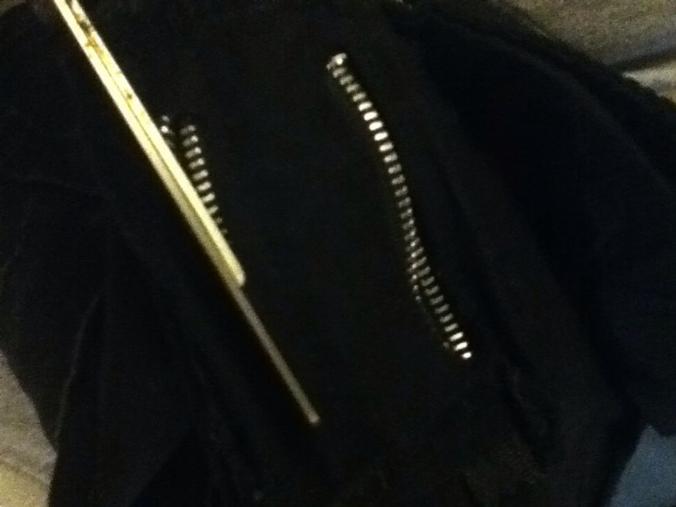 Inside out the jeans. Use regular scissors to poke a hole in the fabric. You can fold it over and cut through that way if your scissors aren't that sharp. Repeat under all of the zippers.