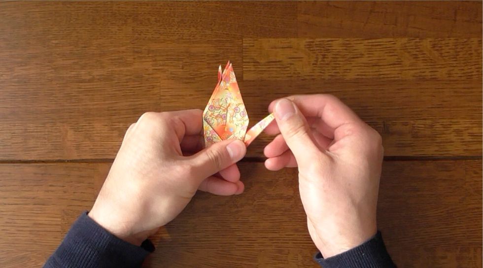 Inside-reverse fold left point up.  Fold in progress.