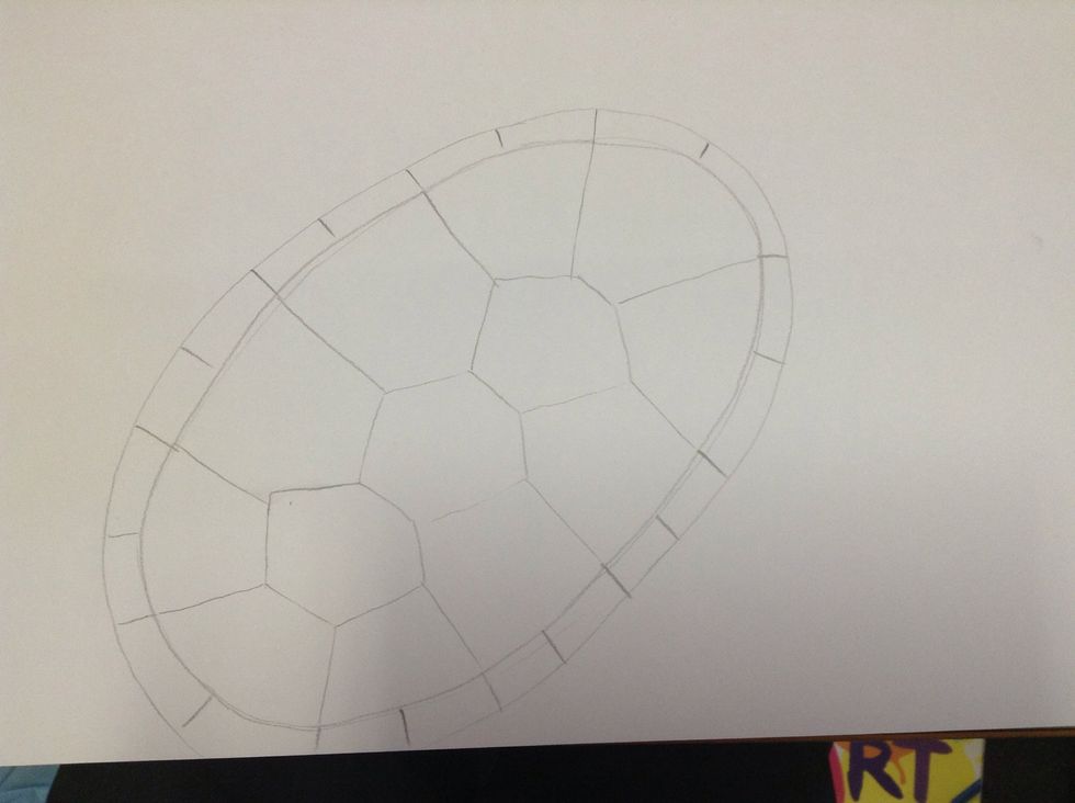 Inside the two ovals, continue the lines from the shell. Add a line in between each. This will create the edge of the turtles shell.