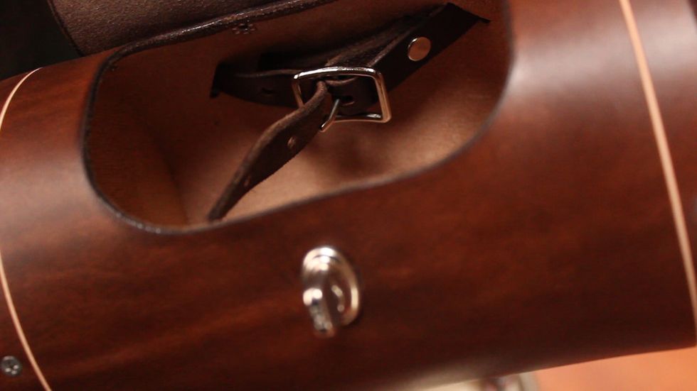 Inside, you'll find a belt. Unbuckle the belt on the inside.