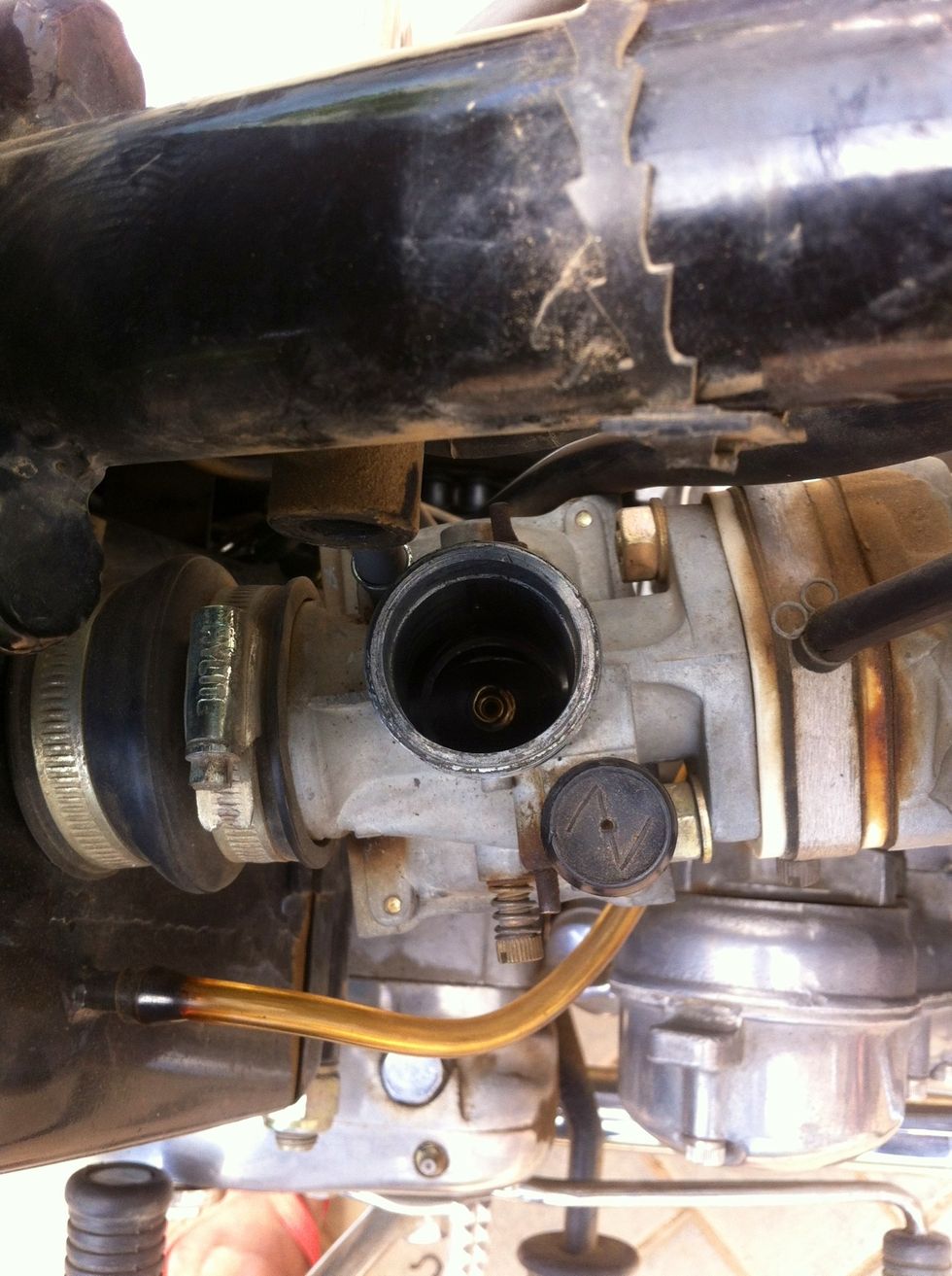 Inspect the carburetor cylinder, clean if required and cover it until reinstallation of the piston so debris and dust don't fall in while you are busy doing the replacement.
