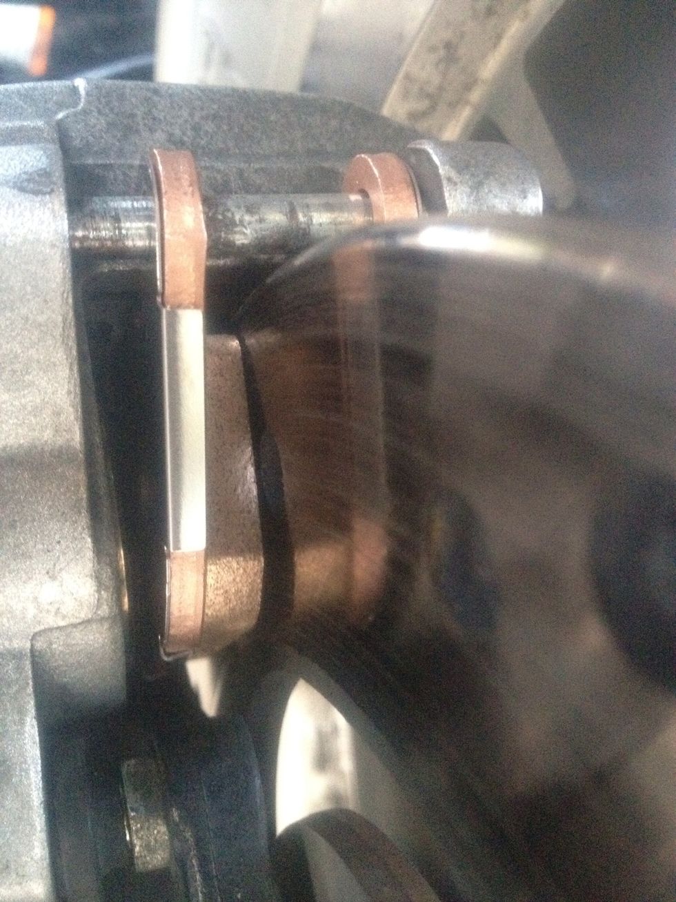 Install new outside brake pad using same orientation as a previously removed pad. Make sure front mounting tab is seated in retainer clip and friction pad is facing rotor.