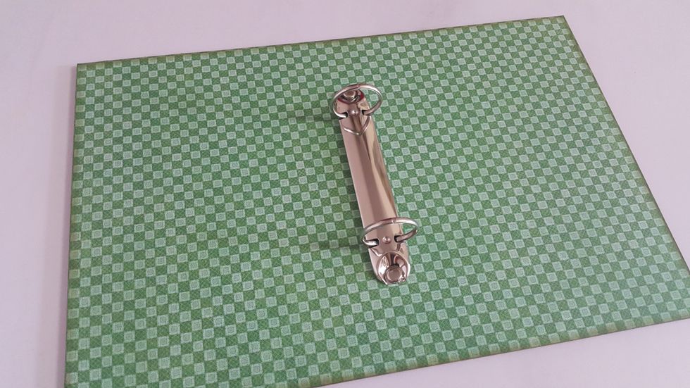 Install the ring binder on one of the chipboard, then adhere the other piece back to back