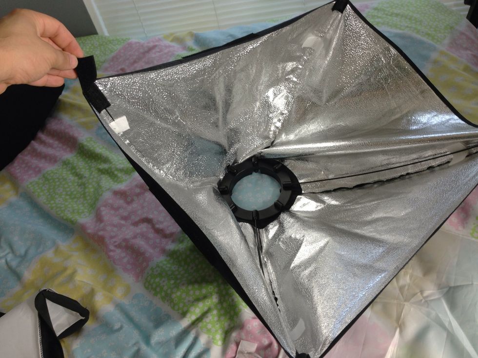 Install two more pins, on either side of the first pin that was installed. one for each corner. Make sure to leave the corner with the extended vector flap to be installed last.