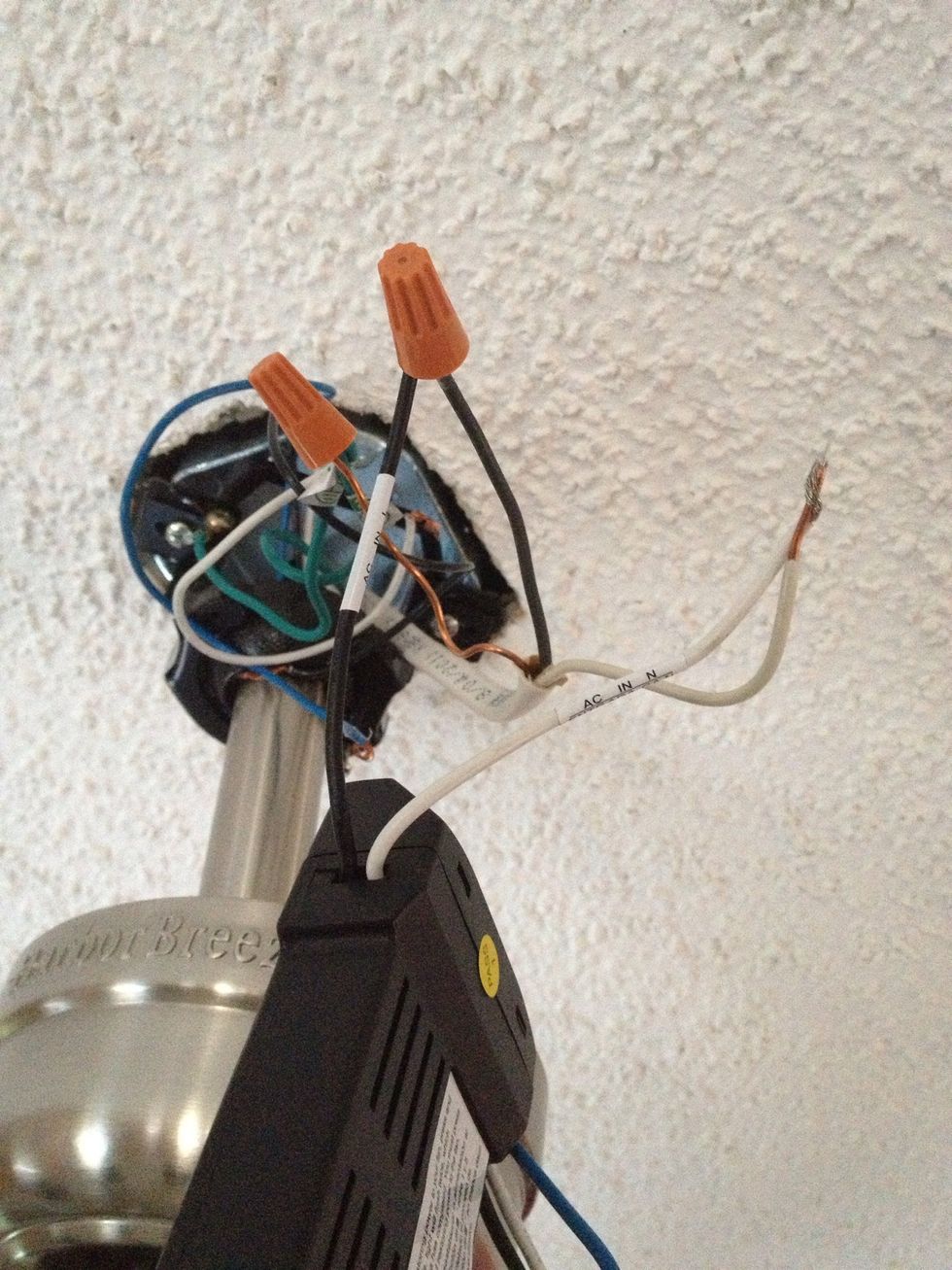 Install your box "in between" the wires. What I mean is the black wire coming from your house now connects to one side of your box, then black wire from the box connects to the fan