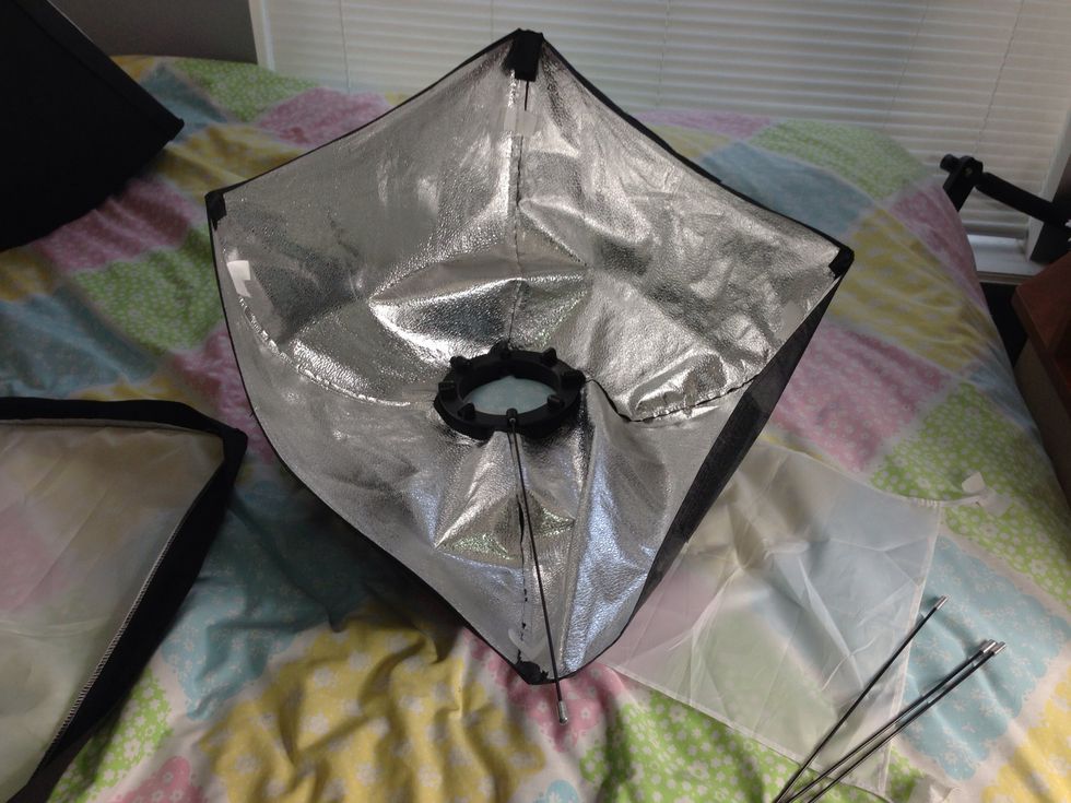 Installed the first pin directly opposite from the corner that has an extended flap of Velcro. Insert the pin into the ring first and then into the velcro pocket on the corner of the softbox.