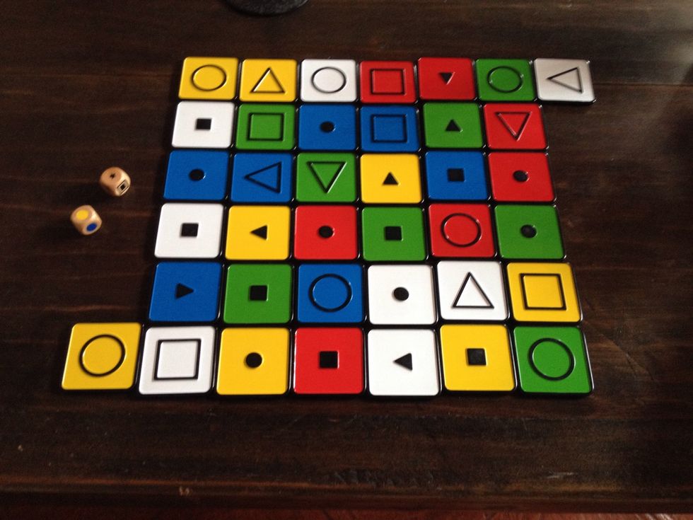 Introduce corner tiles. Tell learner their goal is to move three tiles to his/her corner tile. The turn is over when the tile reaches their corner tile.