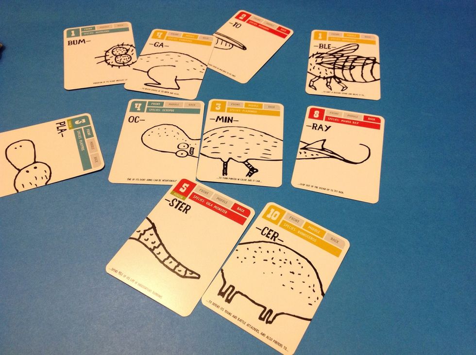 Introduce the cards and describe the front (blue), middle (yellow), and back (red) of the creatures. Let the learner explore the cards and make his/her own creatures.