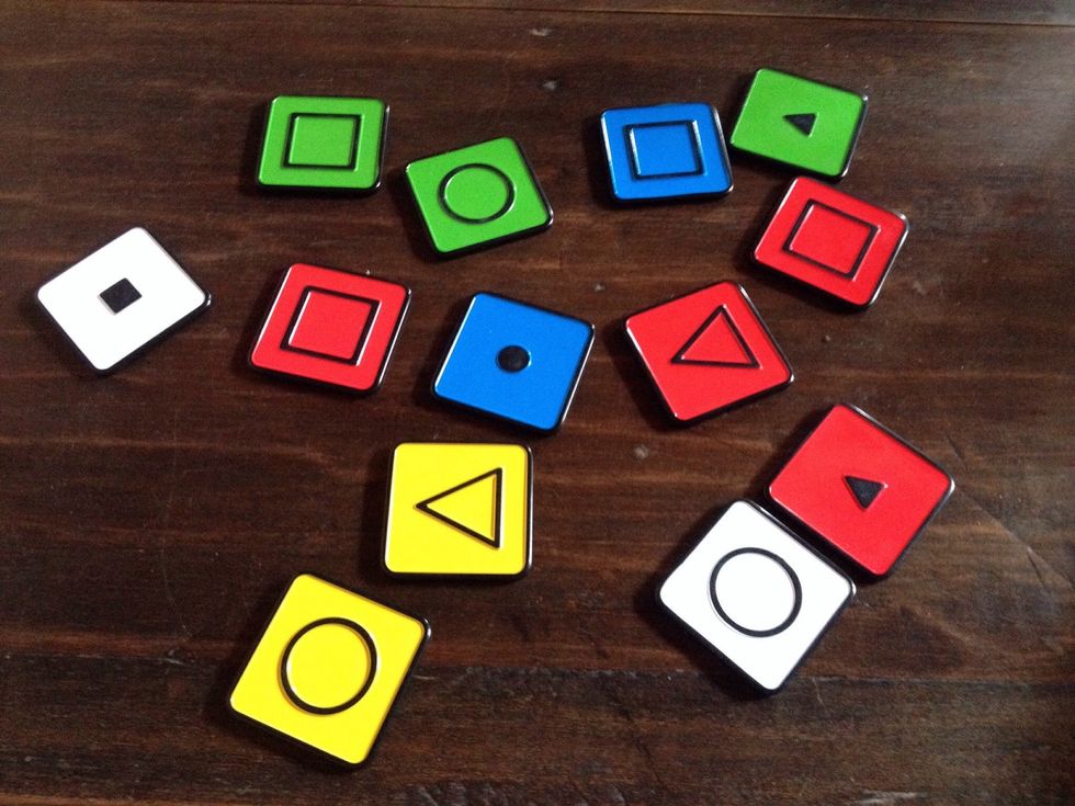 Introduce tiles. Ask how they are alike and different. You may want to use a textual cue that lists: SHAPE, COLOR, and SIZE.