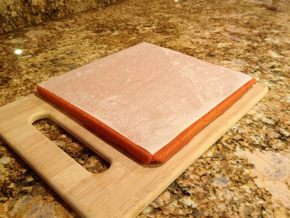 Invert the solid block onto a cutting board. It should slip right out of the pan. Peel off the parchment paper.