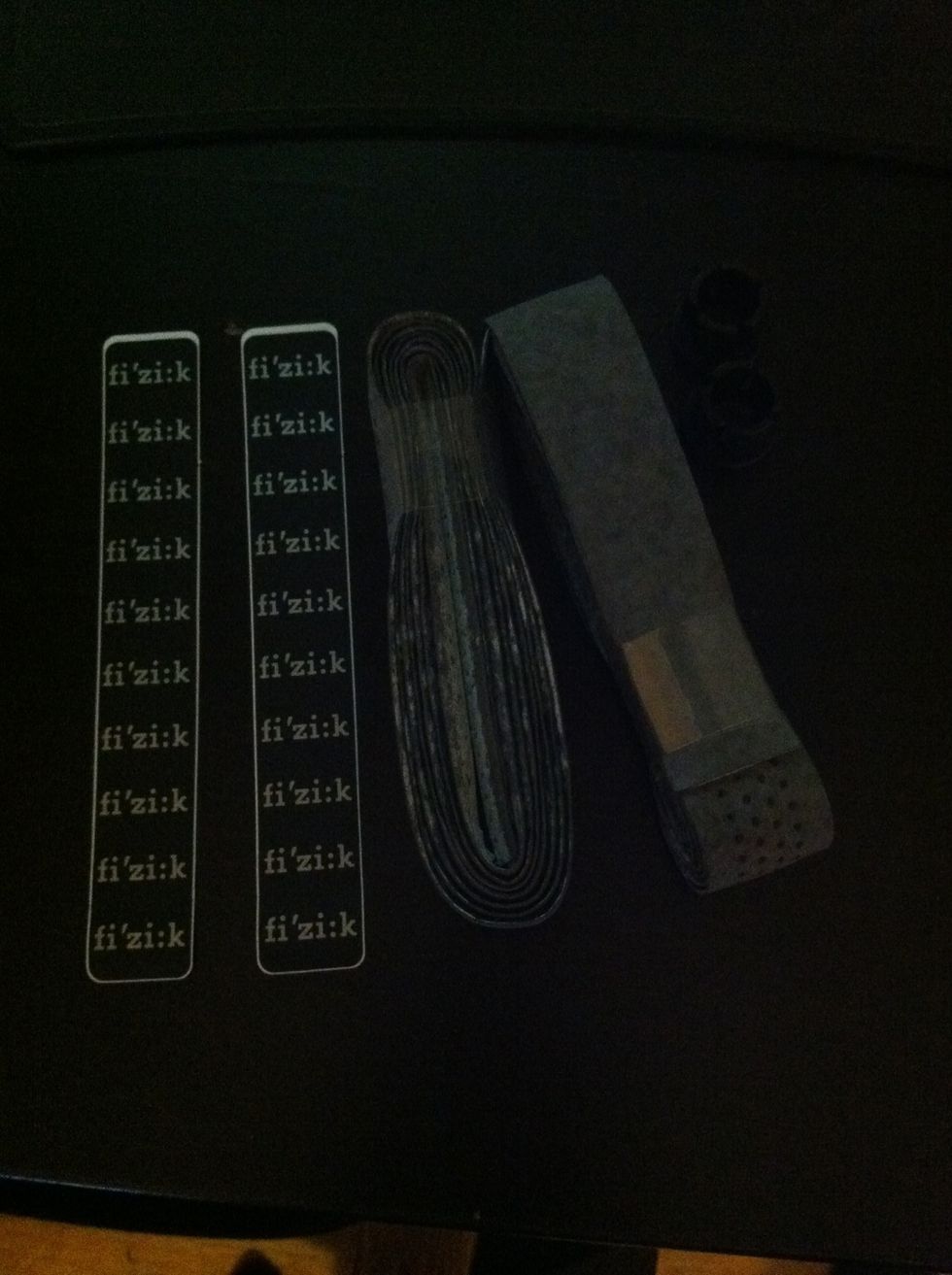 It comes with grip tape, tube caps and end tape. You can just use electrical tape (black plastic tape) if you don't want the logos.