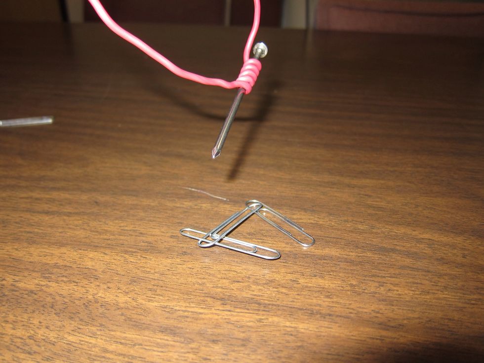 It dropped them again! The paper clips are too heavy.