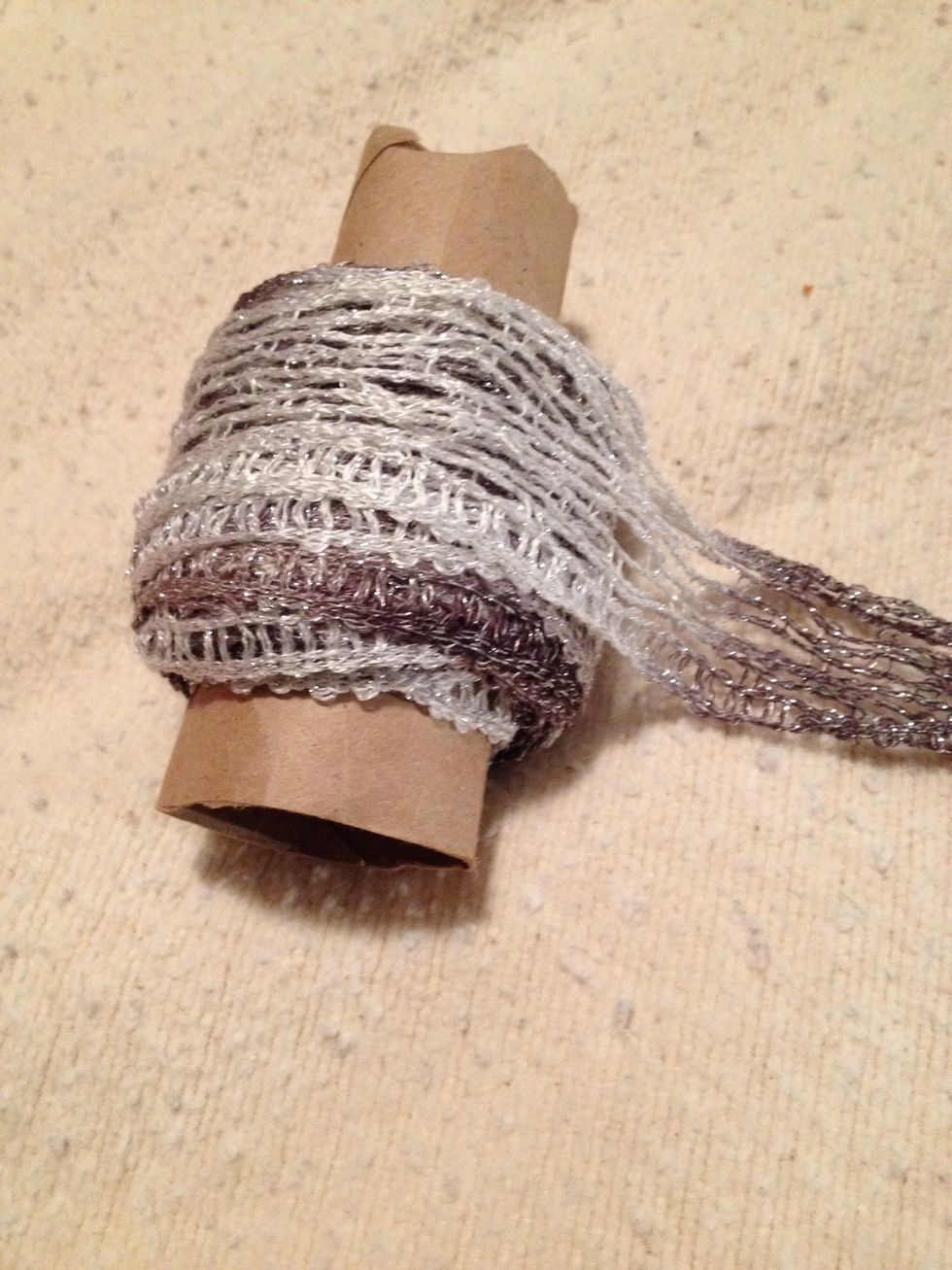 It is easiest to work with if you unravel it and wind it around a paper towel roll tube. You can see the netted texture of the yarn.