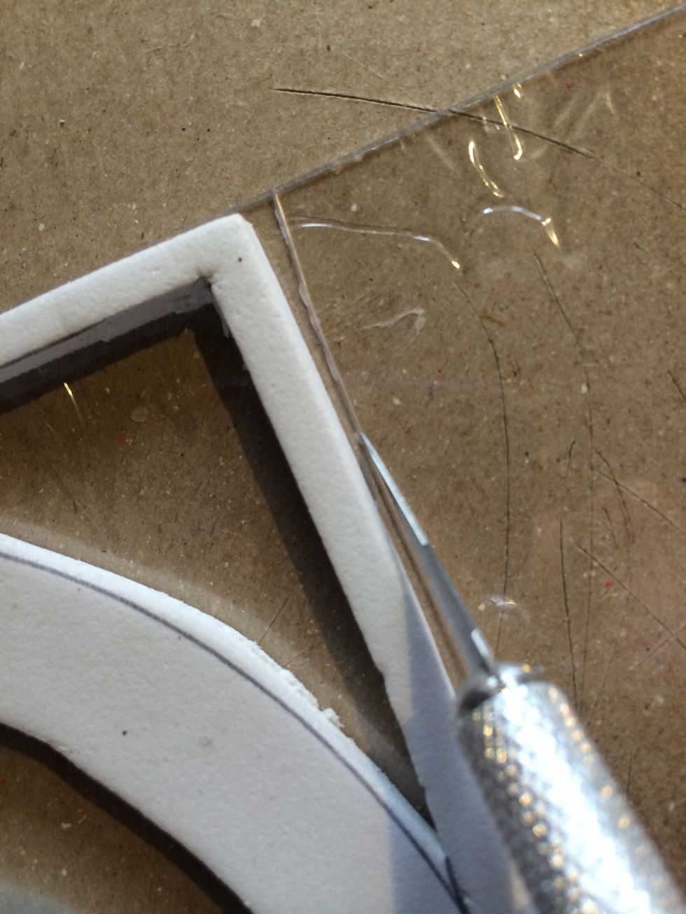 It is super easy to cut your acrylic to size now that you know how big your stamp is. Simply score with your exacto knife around your foam...