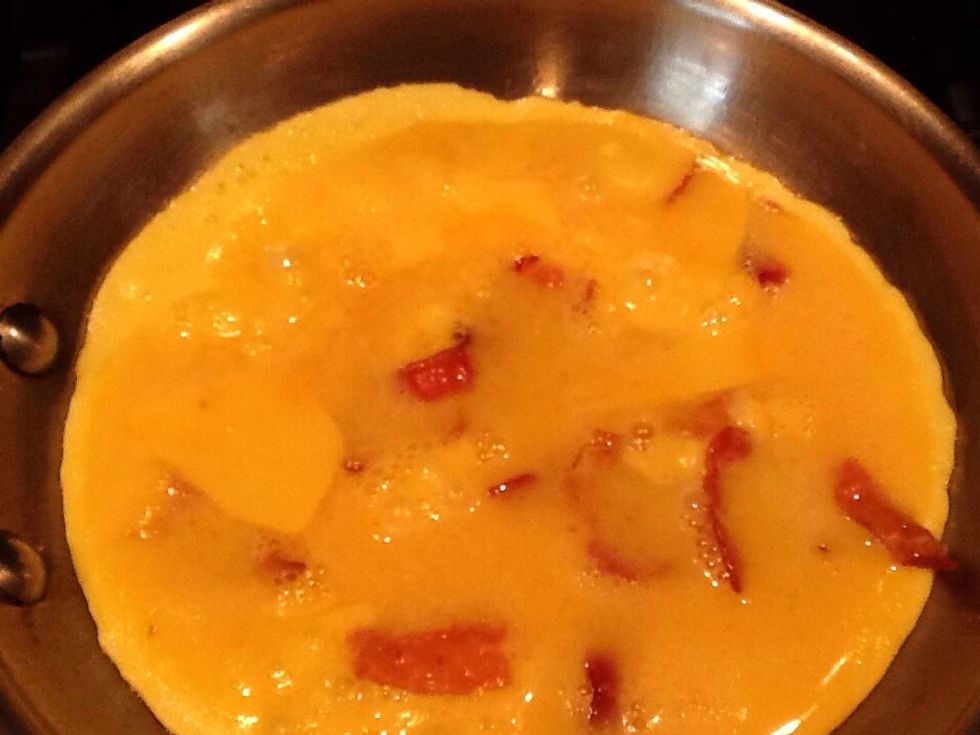 It is time to flip the egg when it gets dark around the edges.