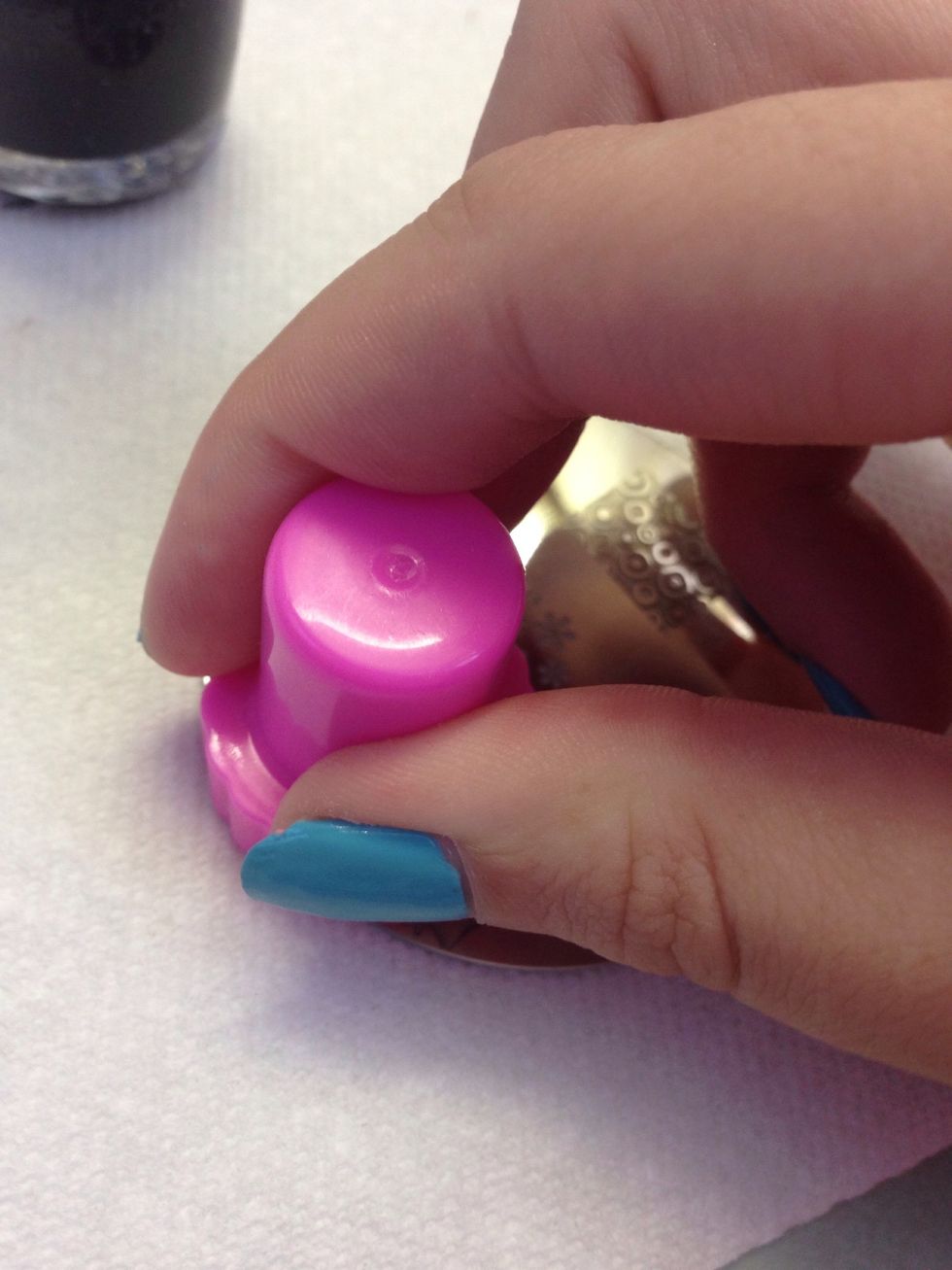 It is very important to do this step as fast as possible. Push the stamper hard onto the design SECONDS after you scrape. You could hold the polish brush and stamp in the same hand to make it easier.