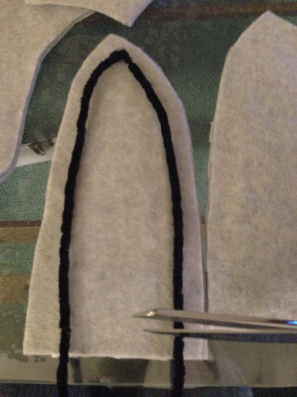 It's a bit too long so i went ahead and cut some off the bottom. We need to be able to see the ears later.  After u made ur bones for each ear and cut them have someone put on the hoodie.