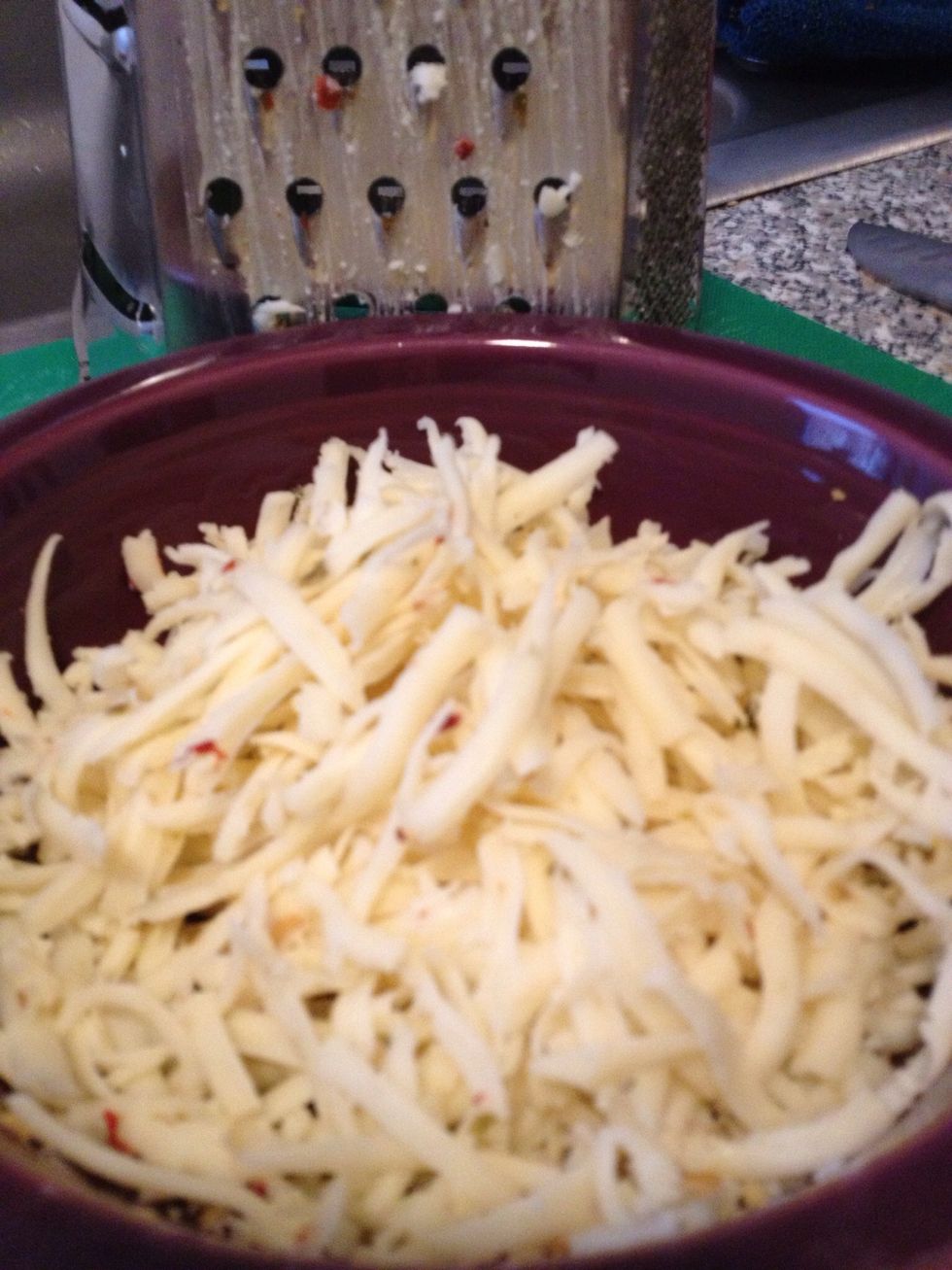 It's a good idea to have your cheese grated at the start. You just have to work quickly if you don't have it grated and perhaps even turn off the flame on your sauce to avoid burning or sticking.