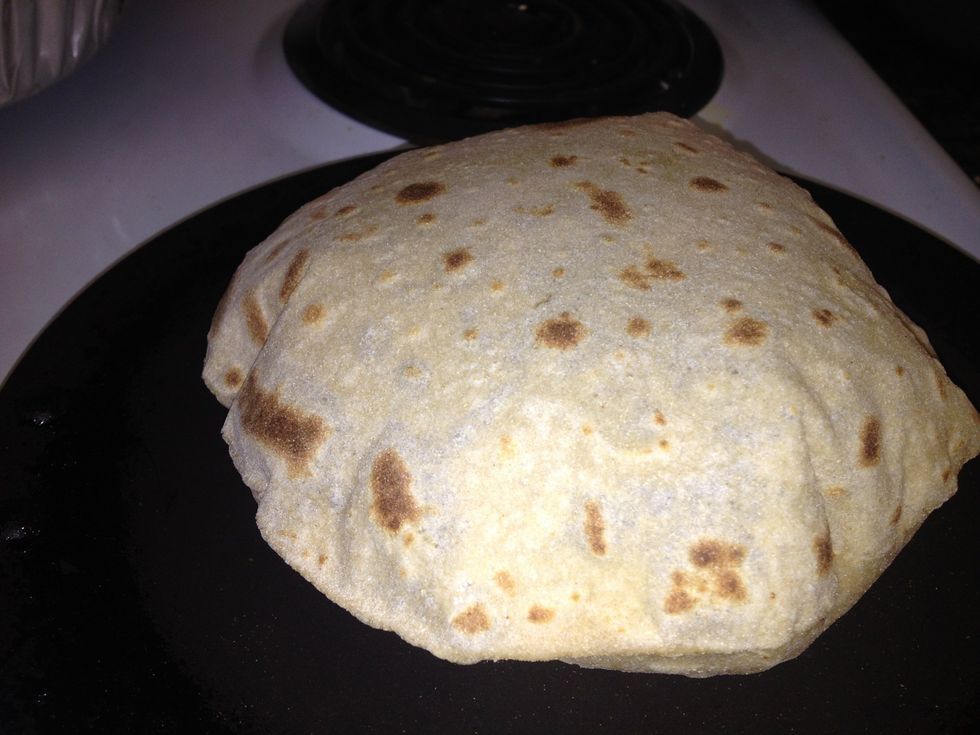It's gonna puff up. Keep pressing the sides softly till the steam fills all the sides. Don't press hard on it and take care of your fingers as the steam inside the bread  gets really hot.