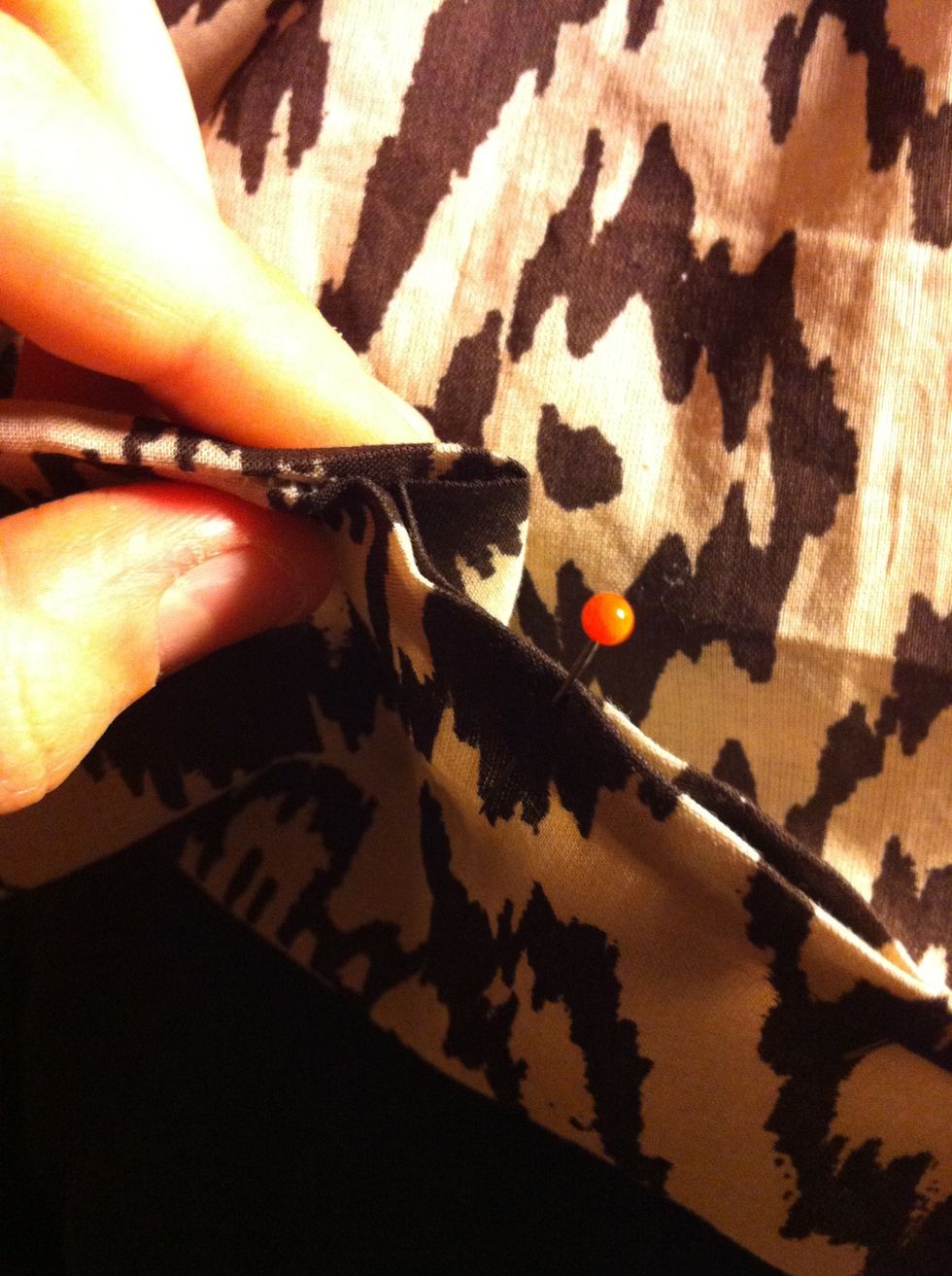 It's likely that the two ends are not exactly the same width. You can tackle the problem by making a neat fold from the excess length before sewing. This way it will hide in the scarf when worn.
