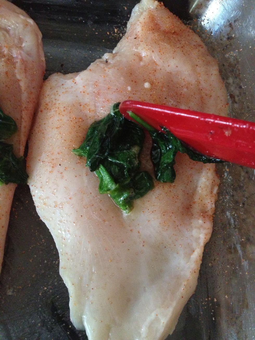 It's now time to put your saut\u00e9ed spinach on to your chicken halves.